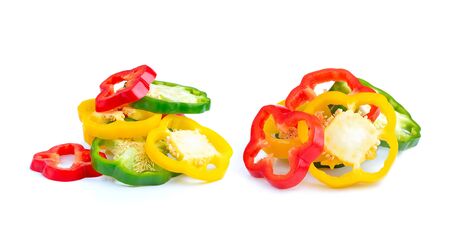 red, green and yellow sliced pepper isolated on white backgroundの写真素材