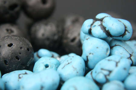 turquoise blue and black gemstones beads on black backgroundの写真素材