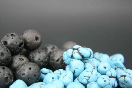 turquoise blue and black gemstones beads on black backgroundの写真素材