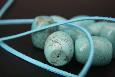 turquoise gemstones beads on black backgroundの写真素材