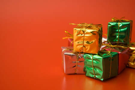 gold silver and green christmas gifts decoration on red backgroundの写真素材