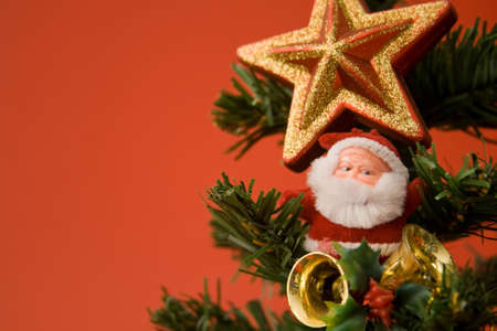 Santa and christmas ornaments on red backgroundの写真素材