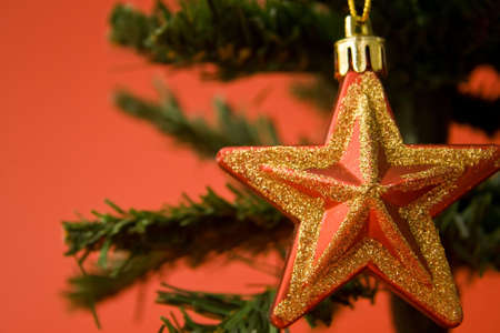 Red and gold christmas ornaments on red backgroundの写真素材