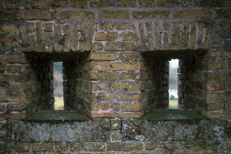Two slits in the brick wall. France. City Bergues.