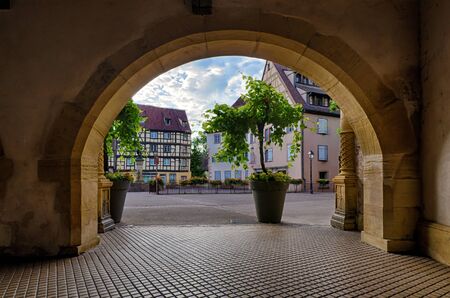 View from the arch to the town of Colmar. Alsace. France. In the background, you can see plants in pots and old houses.の写真素材