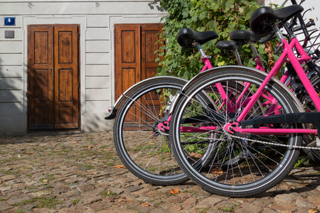 Several bicycles stand at the wall of the old building.の写真素材