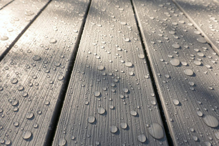 A look at the perspective of gray plastic slats. The surface has an imitation of the wood texture. There are drops of water after the rain. Background. Texture.の写真素材