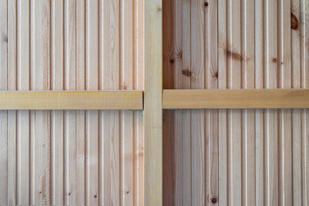 The inner side of the partition is made of wooden lining. The cross from the bars of the frame divides the image field into four parts. The structure of a light, unpainted wood is visible. Backgroundの写真素材
