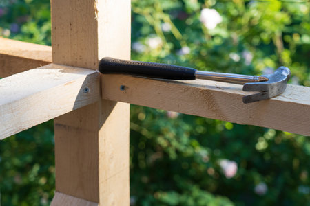 Fragment of the structure of the frame of a wooden building. Connection of several bars. There is a...