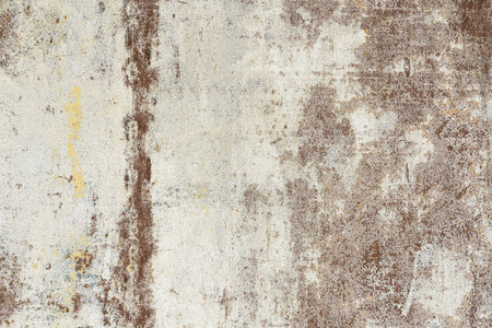 Fragment of an old rusty iron wall with cracked and yellowed white paint. There is a vertical strip...