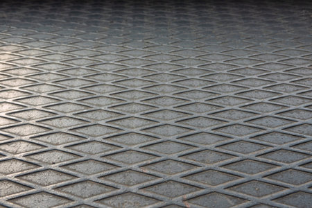 Perspective view of a floor made from old worn corrugated steel sheet. There is an ornament in the...
