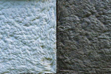 The junction of black and white decorative panels on the wall of a building. Close-up. Background. Texture.の写真素材