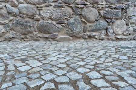 A combination of a stone pavement and a decorative wall made of large natural stones. Background. Texture. Detail.の写真素材