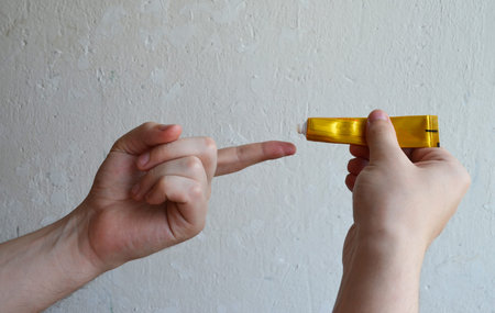 
Ointment in a gold tube in hands, cream, cosmetic smear