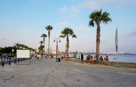 embankment with palm trees and people having a restのeditorial素材