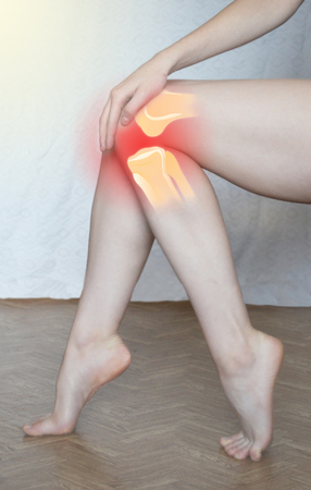 Knee painful - skeleton Illustration medical concept. Health care concept, woman suffering from pain in knee, closeupの写真素材