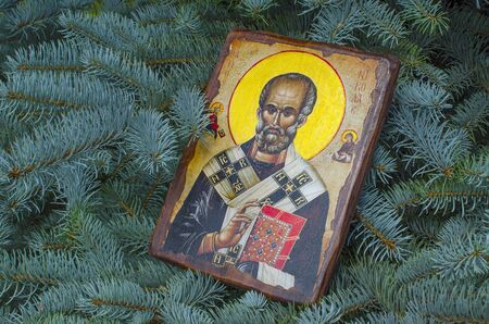 UKRAINE, ODESSA REGION, VILLAGE PETRODOLINSKOE JUNE, 30, 2019: Icon of St. Nicholas on the background of branches of blue spruceの写真素材