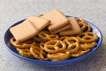 Delicious biscuits on a blue saucer and marble top.の写真素材