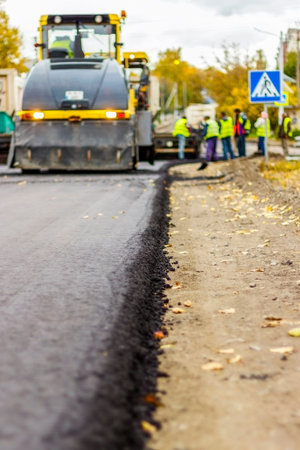 Road repair, the replacement of asphalt using machinery.