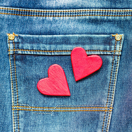 two hearts on a background of a jeans pocket close-up.Valentines Day background consept.