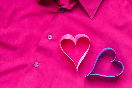 On the background of the pocket of the red shirt are the hearts. Valentine's day concept.