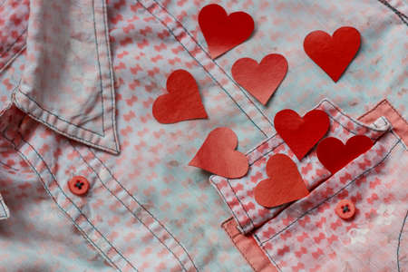 two hearts on the background of a pink shirt pocket. close-up.Valentines Day background consept.の写真素材