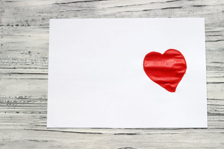 On a piece of white paper, paints painted a heart. Valentine's Day .
