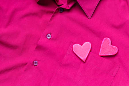 Hearts on the background of a red shirt pocket. The concept of Valentine's Day.の写真素材