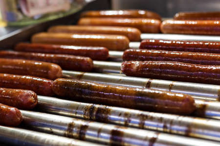 Freshly cooked sausages on a grill close-up. A background of sausages cooked on charcoal.の写真素材
