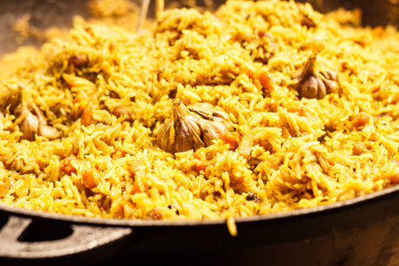 Fresh appetizing pilaf. Cooked with fried lamb, rice, garlic, carrots in a large caviar.の写真素材