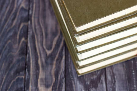 A stack of green books on a wooden table. concept of reading habitsの写真素材