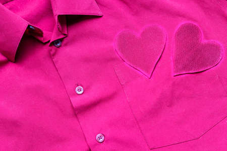 Hearts on the background of a red shirt pocket. The concept of Valentine's Day.の写真素材