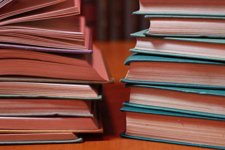 Stacks of colored books on a wooden table. concept of reading habitsの写真素材