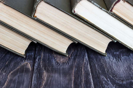 A stack of green books on a wooden table. concept of reading habitsの写真素材
