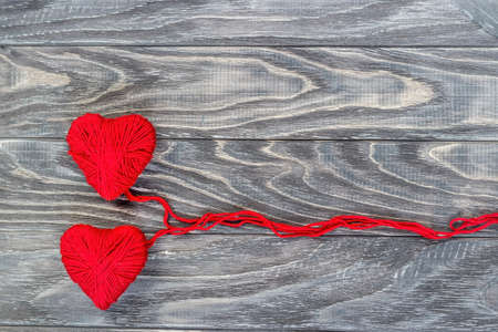 Heart in the form of a string of threads from which a red sweater knits. Valentines day concept.の写真素材
