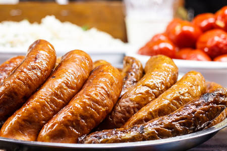 Freshly cooked sausages on a grill close-up. A background of sausages cooked on charcoal.の写真素材