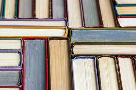 Stacks of colored books on a wooden table. concept of reading habits