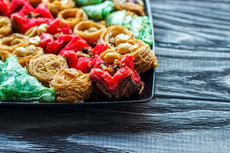 Turkish dessert. Oriental sweets with nuts and honey on a wooden background.の写真素材