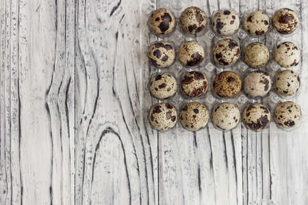 For sale quail eggs in a transparent tray, a tray for storing quail eggs, a symbol for the Easter season. Healthy eating.の写真素材