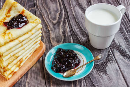 Pancakes on a white plate with honey and a cup of milk. Tasty breakfast.

Homemade pancakes with jam, close-upの写真素材