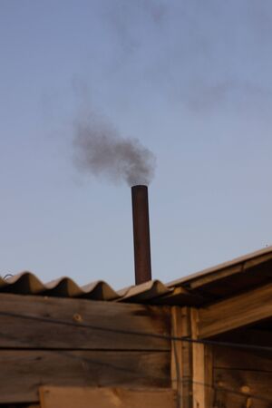 kindling bath in full swing, belching black smoke from the chimneyの写真素材