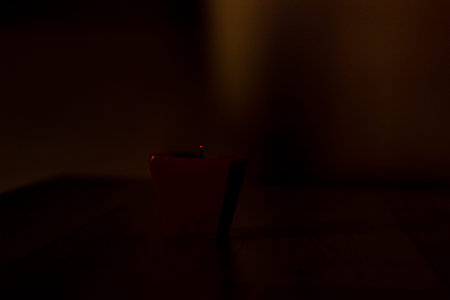 Extinguished candle on black background with copy space.