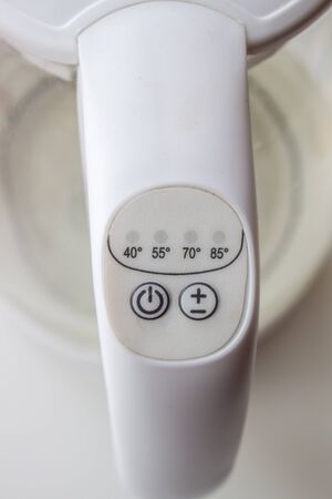 The power and temperature button on the electric kettle is white..の写真素材