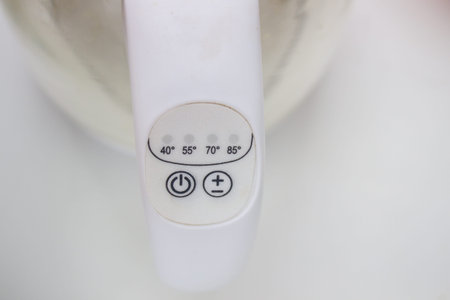 The power and temperature button on the electric kettle is white..