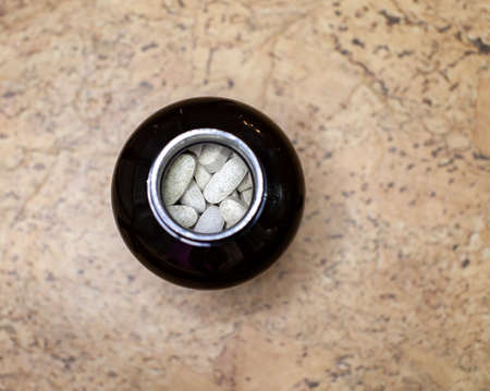 Various capsules and tablets with food additives or medicines in a jar. The view from the topの写真素材