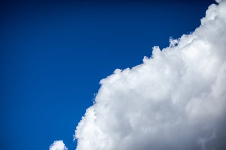 Big white clouds in a blue sky close-up. There is a place for the text. The concept of cleanliness...