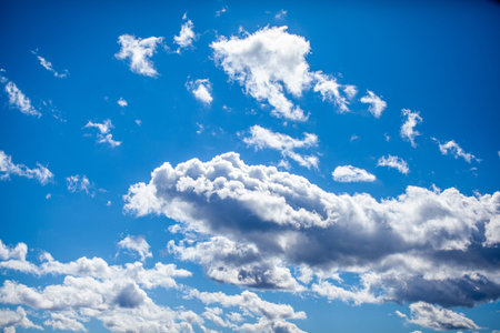 Big white clouds in a blue sky close-up. There is a place for the text. The concept of cleanliness...