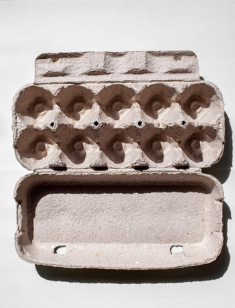 Gray egg carton without eggs on white background. egg carton box made from recycled paper with...