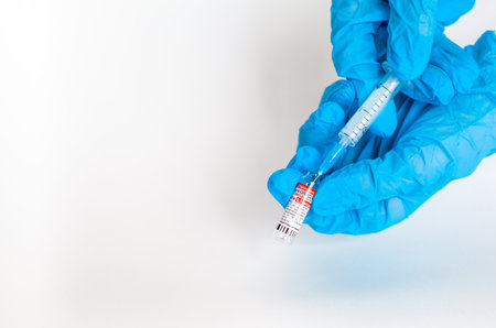 Kemerovo, Russia, July 2021. The coronavirus vaccine is in the hands of a doctor, a syringe. Coronavirus Covid 19 vaccine Sputnik V, local name GamCovidVac, produced in Russia and ready for injectionのeditorial素材