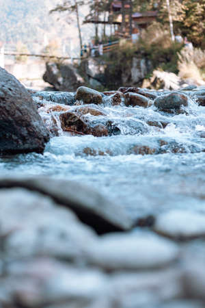 A fast-flowing wide and full-flowing mountain river. Large rocks stick out of the water. Big mountain river Katun, turquoise color, in the Altai Mountains, Altai Republic.の写真素材